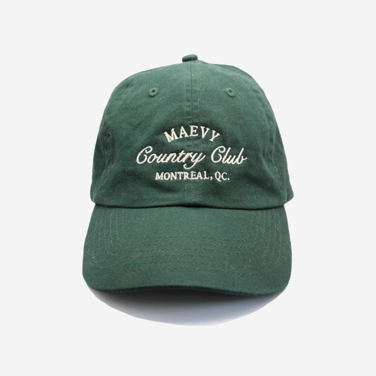 Dark green baseball cap with embroidered white writing that says "Maevy Country Club, Montreal, Quebec"